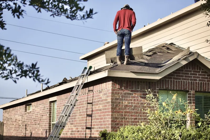Professional roofer working on a residential roof in Crowfoot